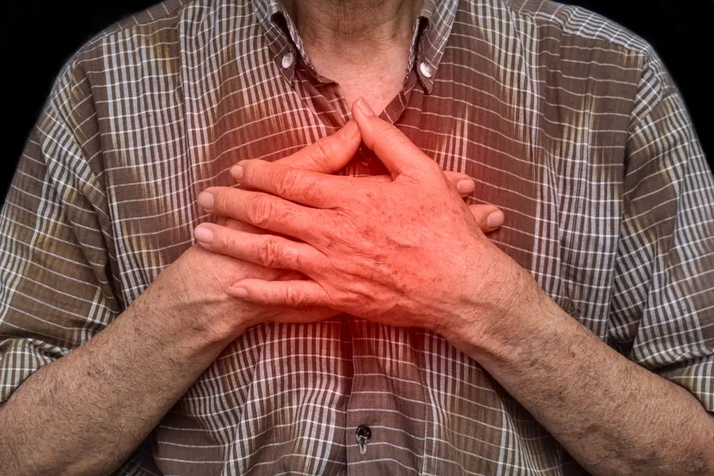 Elder man suffering from central chest pain caused by oesophagitis