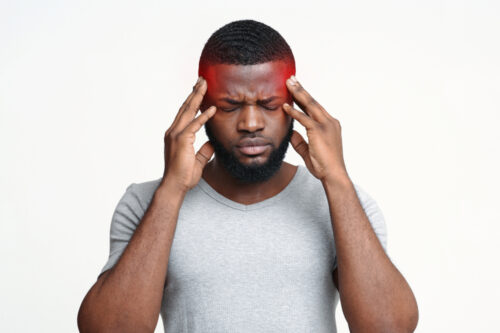 Young,Afro,Man,Having,Headache,,Touching,His,Highlighted,Temples,,Migraine