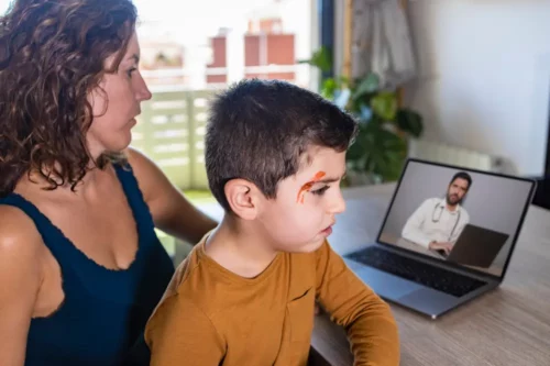 Worried mother consulting doctor on video chat. Wounded child.