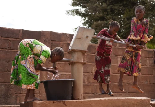 Young girls in Malawi at a public borehole